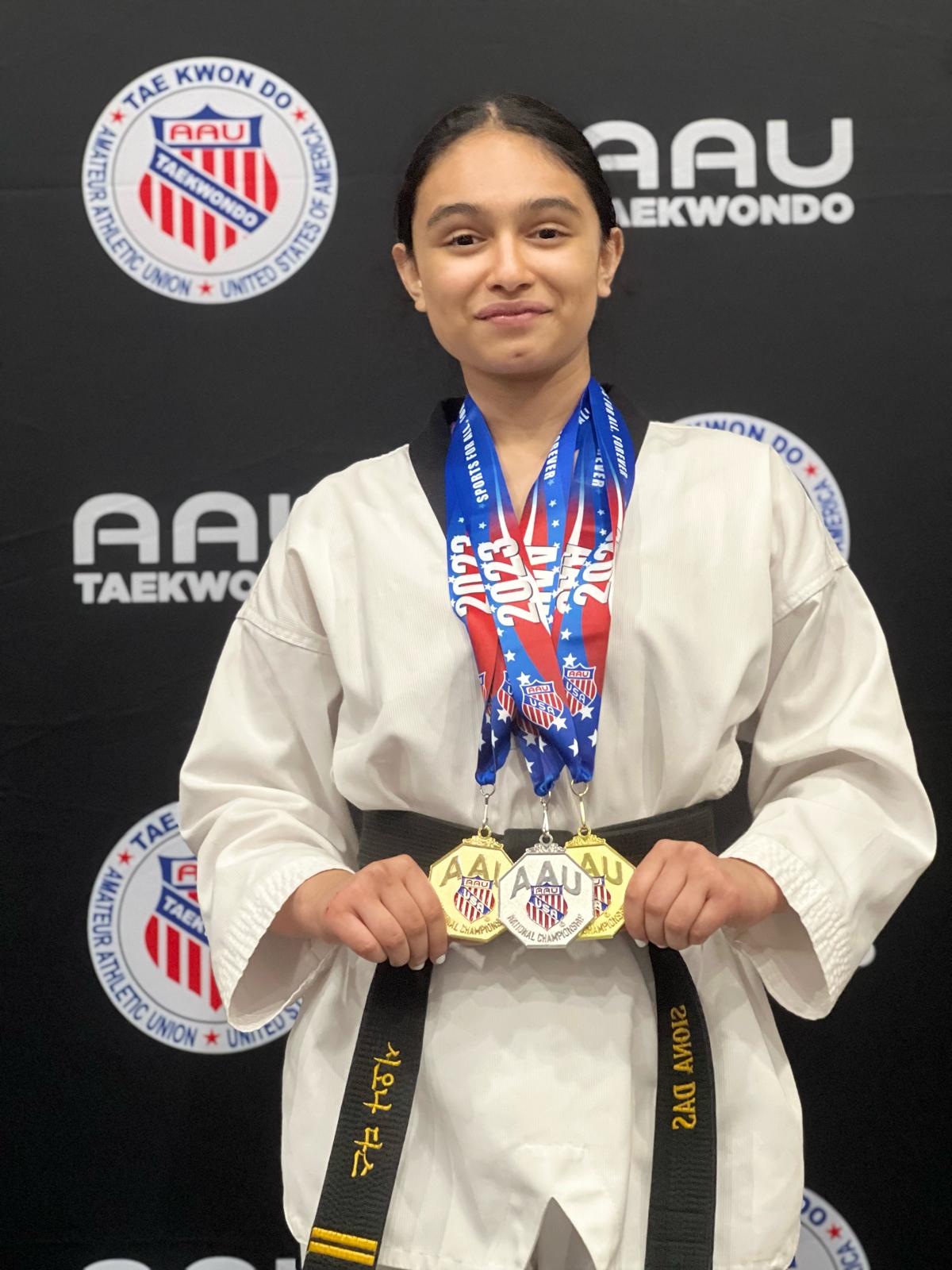 Siona celebrates a major competition milestone with her medals.