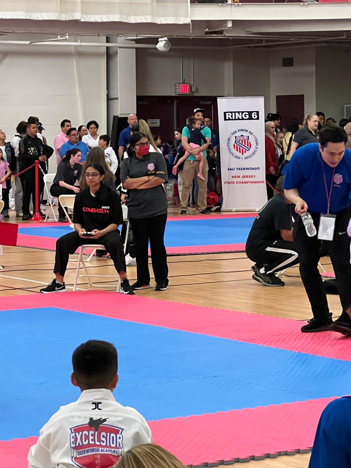 Siona officiates a martial-arts match in a leadership role.
