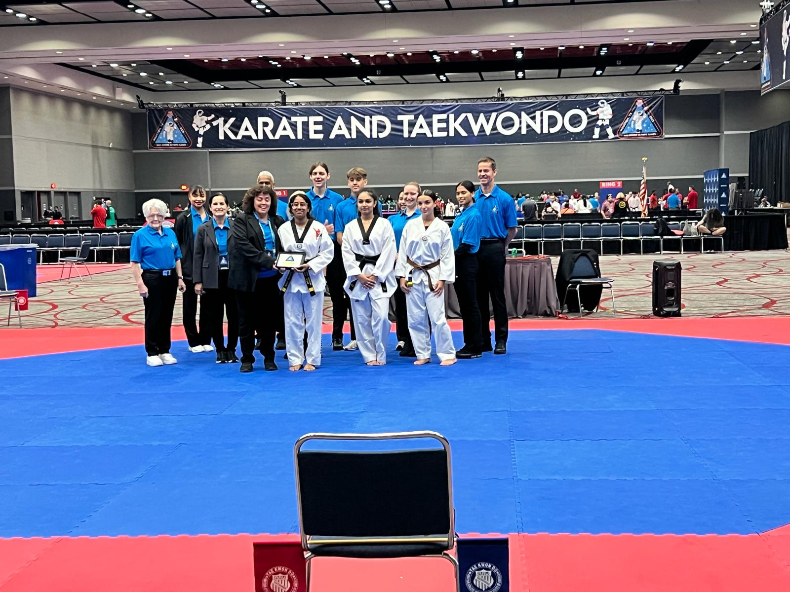 A team recognition moment at a national martial-arts event.